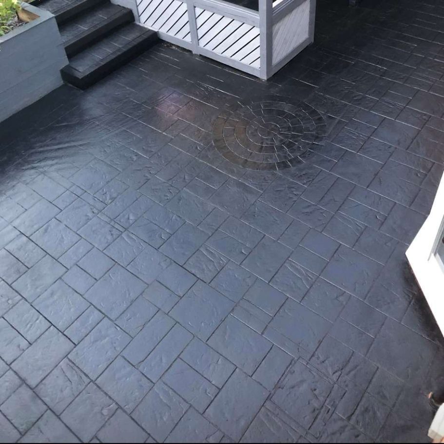 Dark, patterned stone patio with steps and a circular design visible.